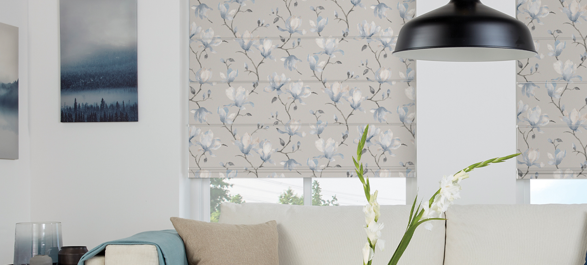 Blue magnolia-patterned Roman blinds in a professionally styled living room